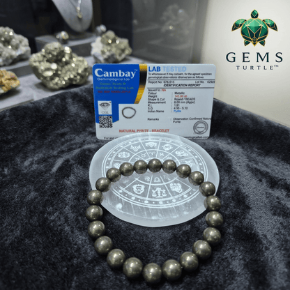 Raw Pyrite Wealth Bracelet displayed on a circular stand with lab certification from Gems Turtle.