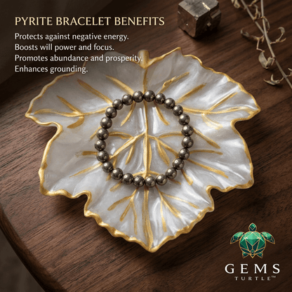 Raw Pyrite Wealth Bracelet on a decorative leaf dish, showcasing its benefits for protection and prosperity.