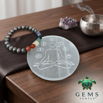 Selenite charging plate for crystals next to a beaded bracelet and incense, symbolizing energy healing.
