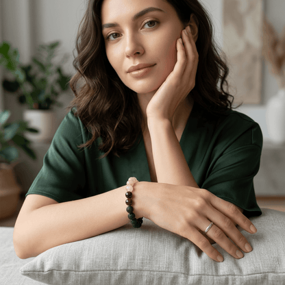 Woman wearing a rose quartz bracelet showcasing lava stone, strawberry quartz, sunstone, and garnet.